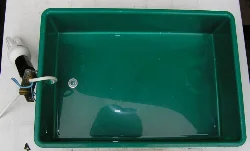 The cord is fed through the middle of one of the short sides, and a bracket is needed to hold the socket.
